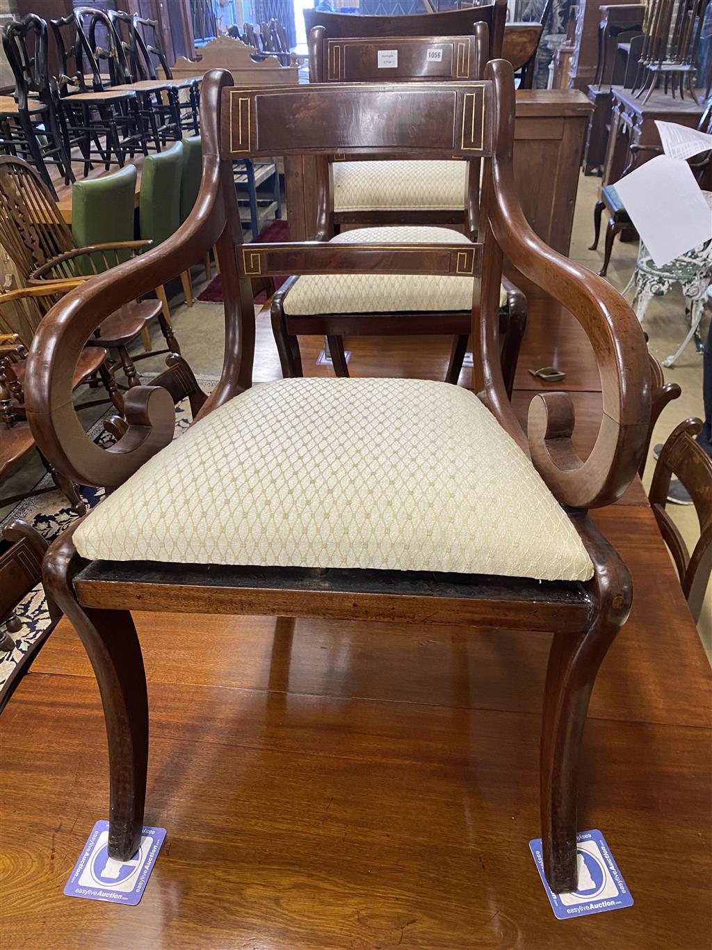 A set of eight Regency mahogany brass inlaid dining chairs, on sabre legs and a similar elbow chair
